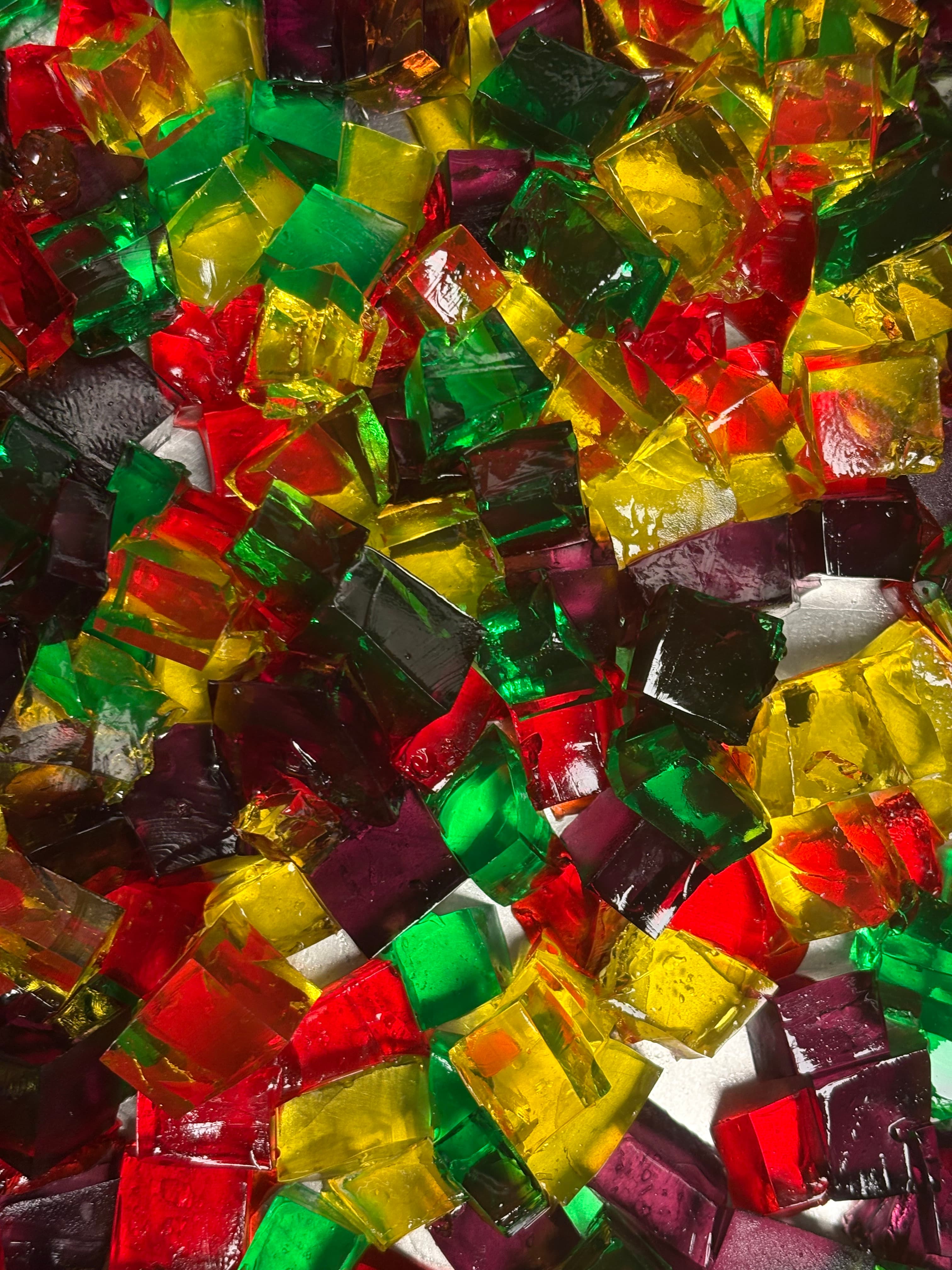 Red, yellow, green, and purple jewel-toned gelatin cubes