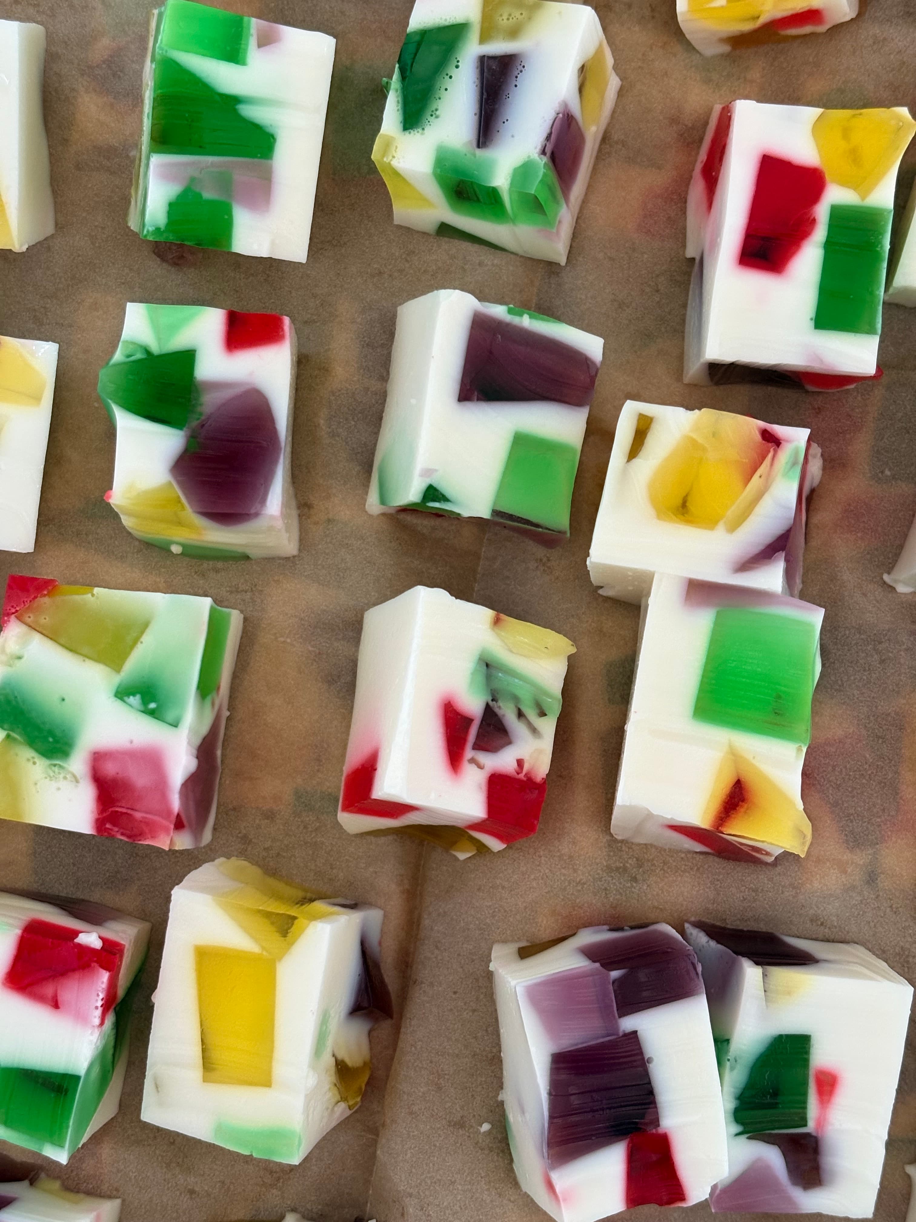 Slices of colorful stained-glass gelatin on parchment