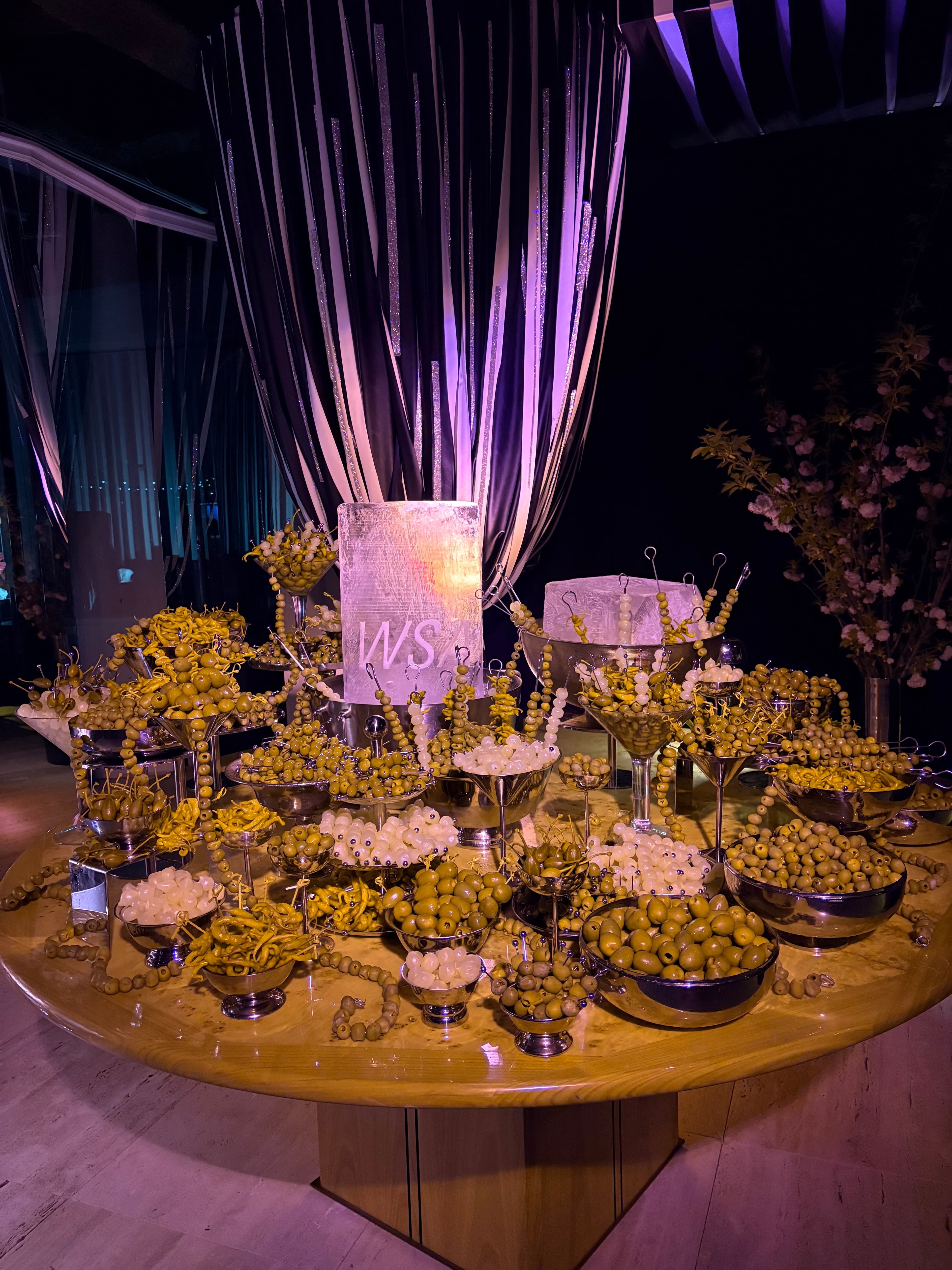 Olive installation arranged around illuminated ice blocks